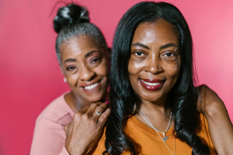 a couple of women standing next to each other, a portrait, by Winona Nelson, pexels contest winner, mature facial features, essence, hgtv, brown