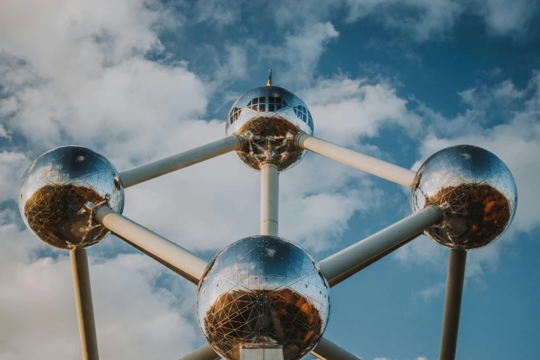 a close up of a metal structure on a cloudy day, inspired by Buckminster Fuller, pexels contest winner, brussels, profile image, energy spheres, big telescope in front