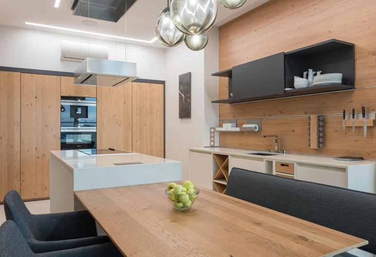 a wooden table with a bowl of fruit on top of it, a picture, luxury bespoke kitchen design, office ceiling panels, caught on camera, celebration