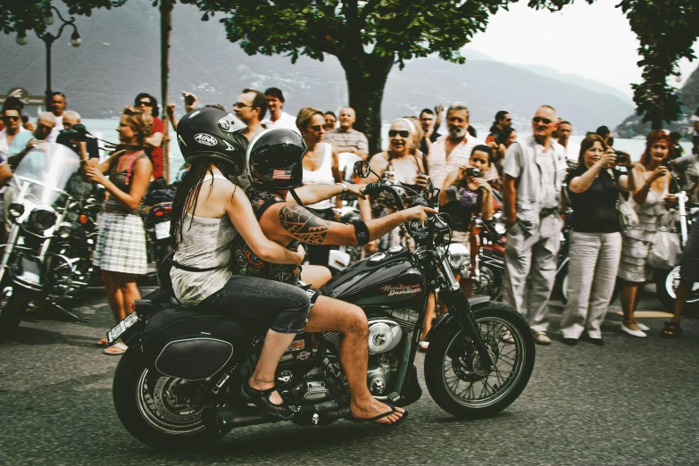 a woman riding on the back of a motorcycle, pexels contest winner, renaissance, people watching, manly, festival, avatar image