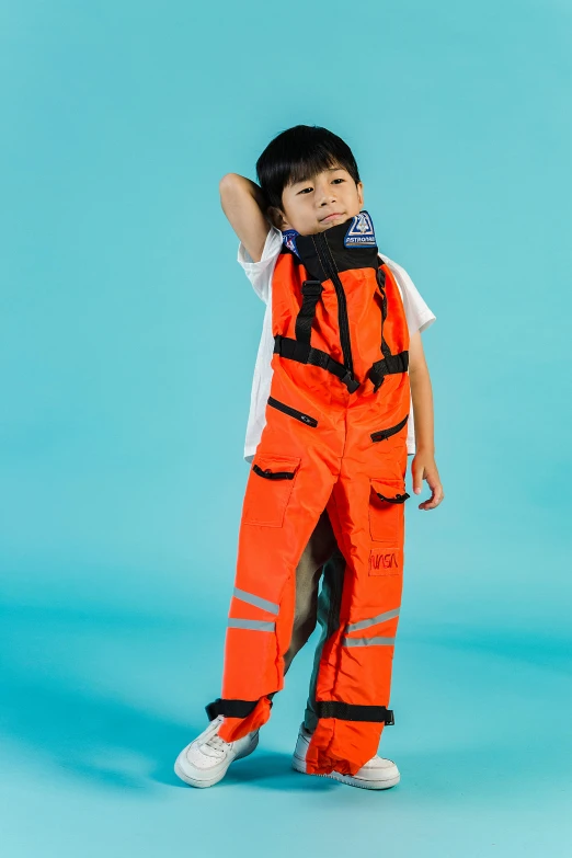 a young boy in an orange space suit, trending on reddit, shin hanga, wearing cargo pants, official product photo, on ocean, orange safety vest