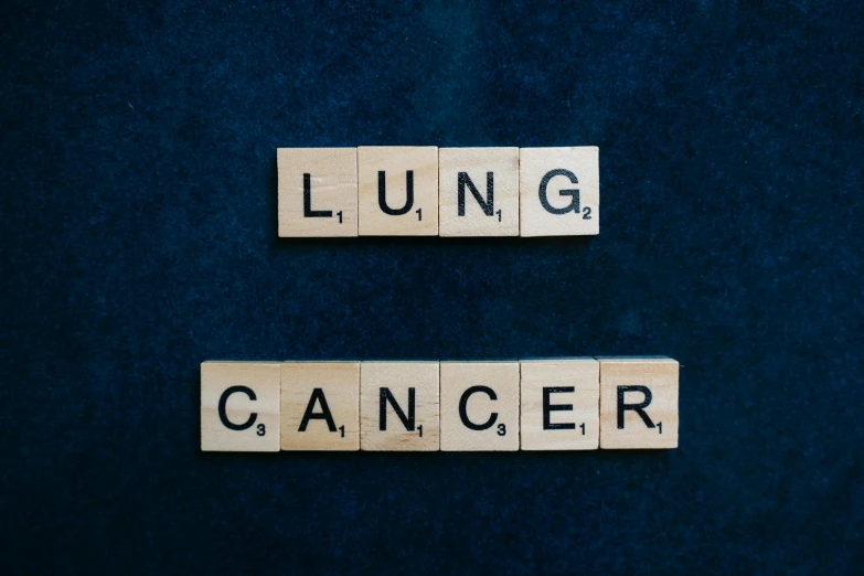 two scrabbles spelling lung and cancer on a blue background, an album cover, by Caro Niederer, shutterstock, on black background, lunar time, a wooden, tan