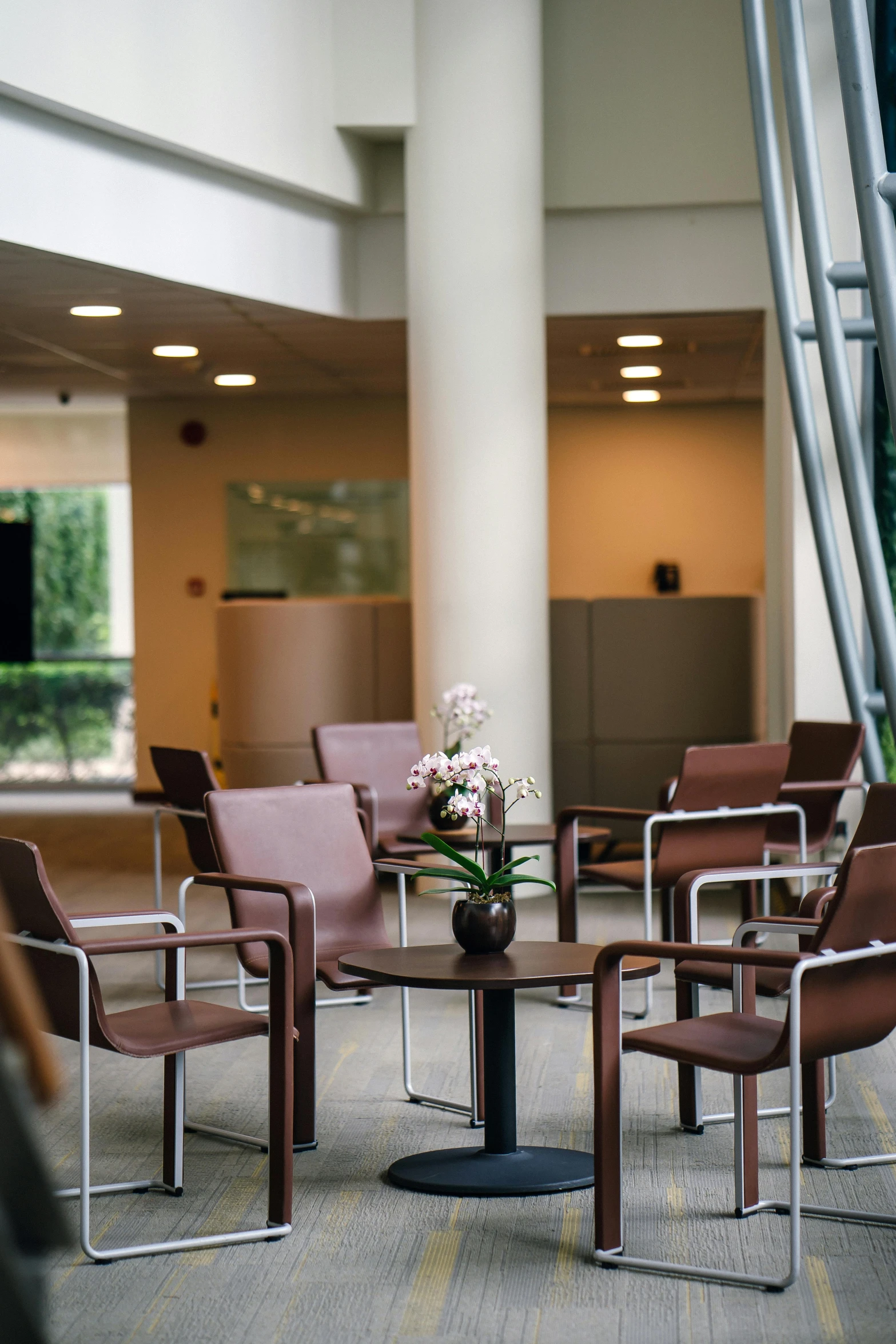 a group of chairs and a table in a room, atrium, espoo, brown, multiple stories