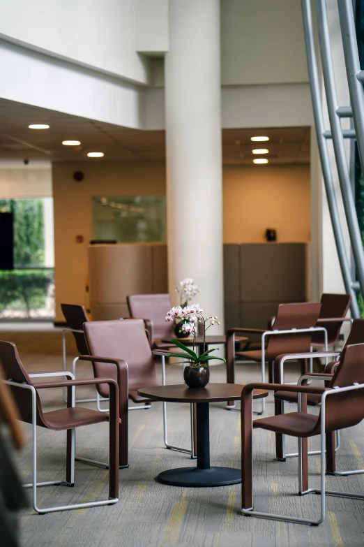 a group of chairs and a table in a room, atrium, espoo, brown, multiple stories