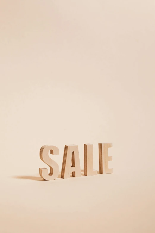 the word sale spelled in wooden letters on a beige background, unsplash, ilustration, burberry, very grainy image, pastel'
