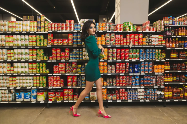 a woman in a green dress in a grocery store, an album cover, inspired by Elsa Bleda, pexels contest winner, hyperrealism, portait of haifa wehbe, a woman wearing red high heels, cans, mia khalifa