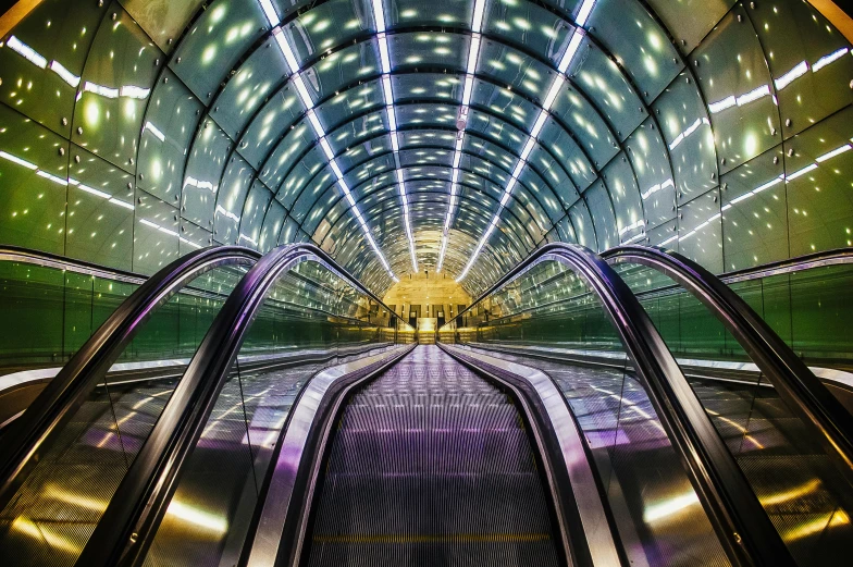 an escalator going down the middle of a tunnel, an album cover, unsplash contest winner, futurism, doors that are cosmic portals, purple tubes, glass and steel, tonemapping