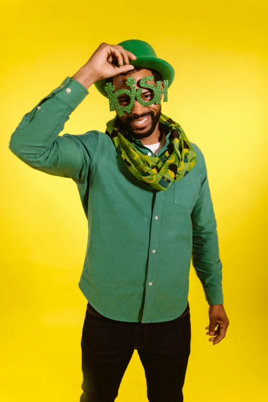 a man in a green shirt and a green hat, inspired by Ras Akyem, shutterstock contest winner, fun pose, wearing a mask, kemetic, clover
