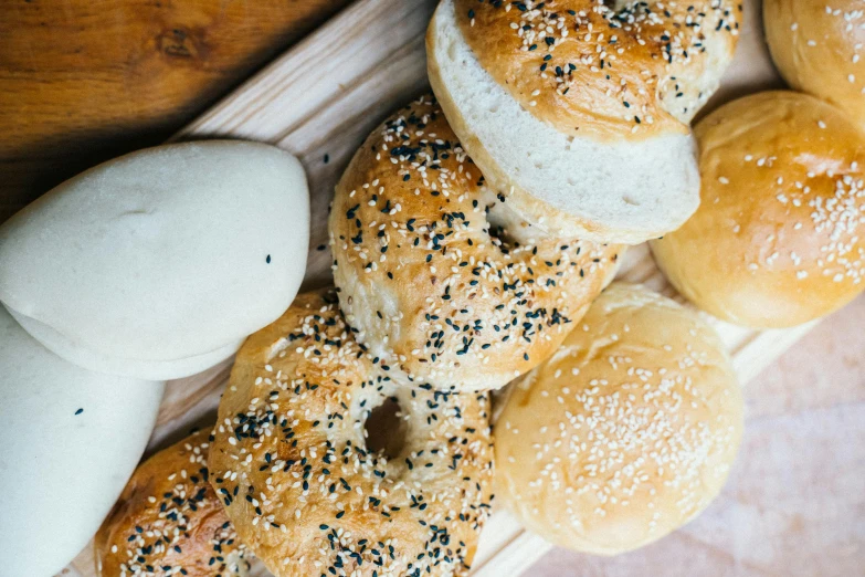 a bunch of buns sitting on top of a wooden cutting board, trending on pexels, bagels, rice, 🦩🪐🐞👩🏻🦳, 2 0 0 0's photo