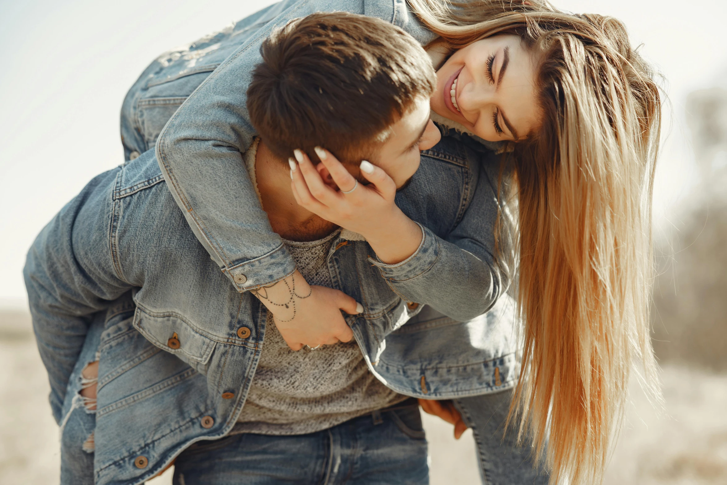 a man carrying a woman on his back, trending on pexels, wearing a jeans jackets, hands in her hair, maxim sukharev, casual game