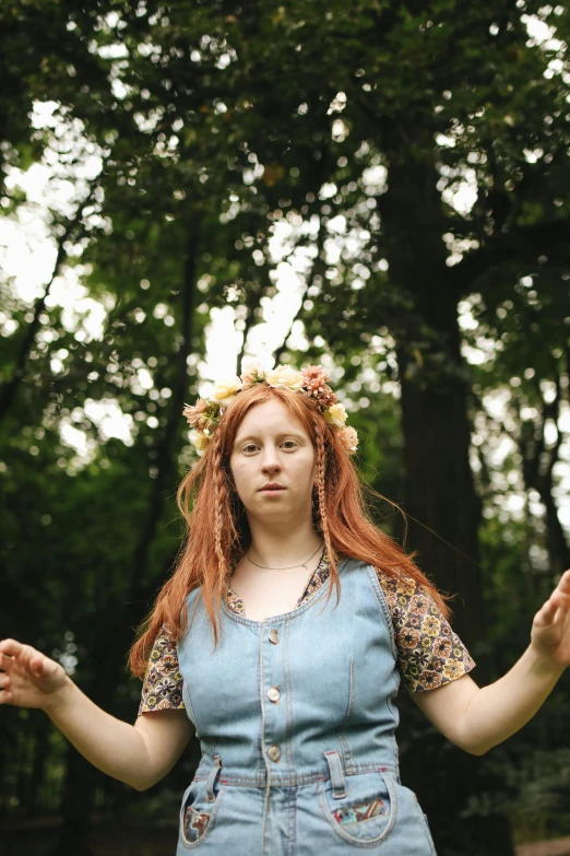 a woman standing on top of a lush green field, an album cover, inspired by Julia Pishtar, unsplash, renaissance, molly weasley, wearing a laurel wreath, shrugging, hr ginger