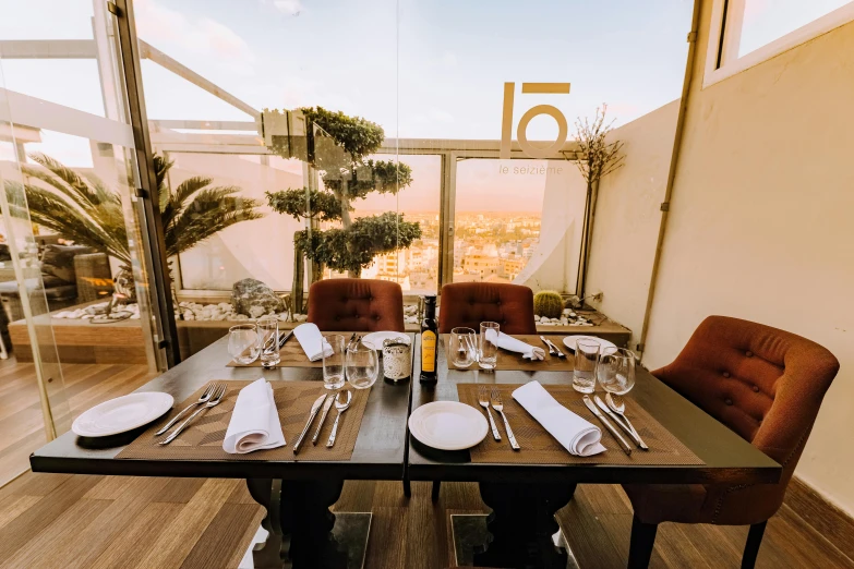 a dining table with a view of a city, a portrait, unsplash, marbella, michelin star food, sky - high view, mezzanine