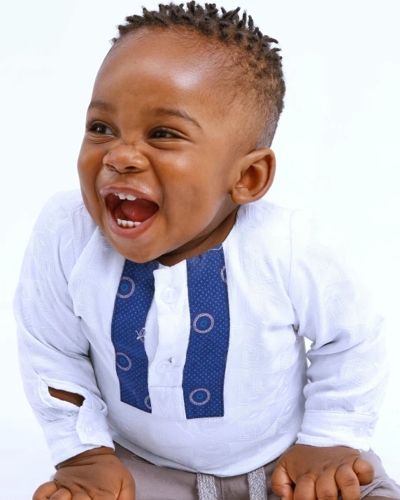 a close up of a baby wearing a shirt and tie, inspired by Ismail Gulgee, pexels contest winner, happening, smiling fashion model, white shirt and blue jeans, african, embroidered robes
