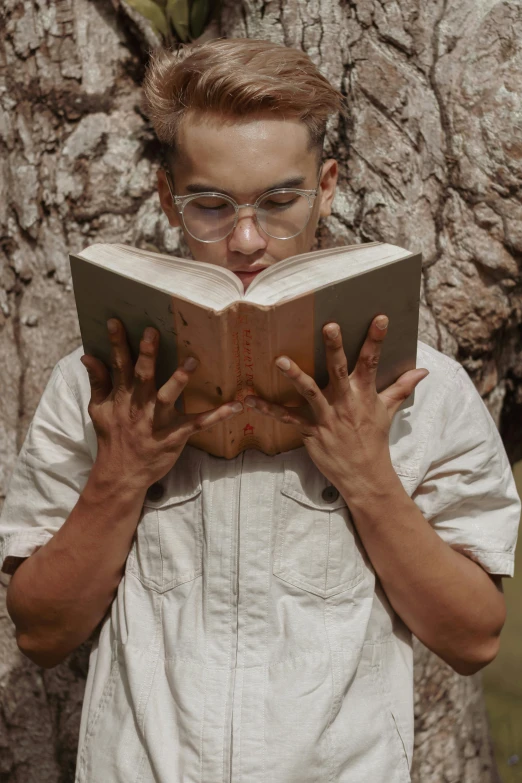 a man reading a book in front of a tree, pexels contest winner, renaissance, wearing small round glasses, gif, ashteroth, frontal shot