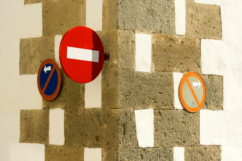 a couple of signs that are on the side of a building, by Carlo Carrà, unsplash, bargello, random circular platforms, mixed materials, 15081959 21121991 01012000 4k