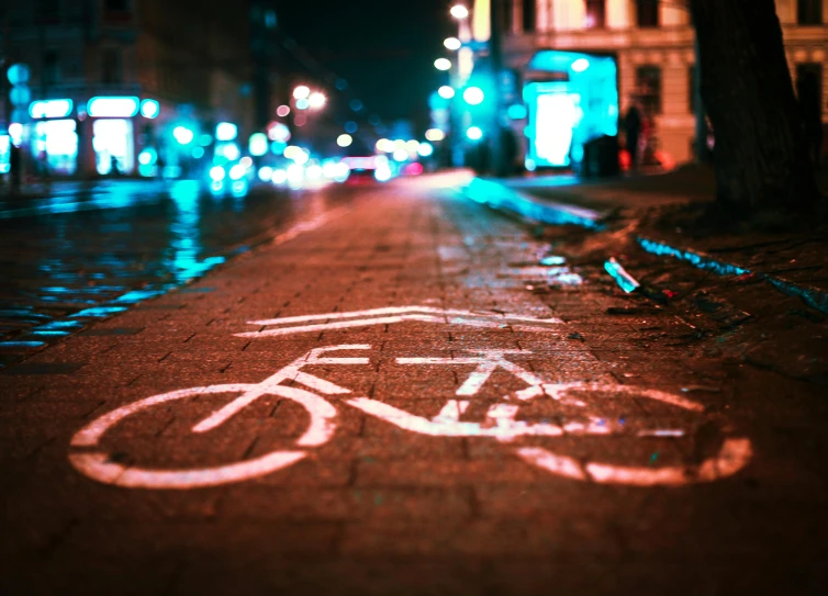 a bike lane on a city street at night, pexels contest winner, graffiti, 🚿🗝📝, cyberpunk signs, flattened, promo image