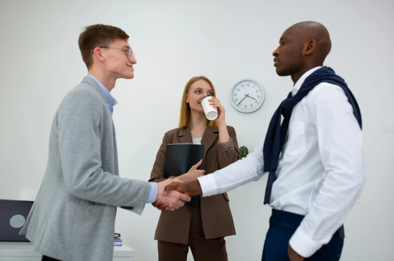 two men and a woman shaking hands in an office, pexels contest winner, professional sports style, multi chromatic, looking sad, office clothes