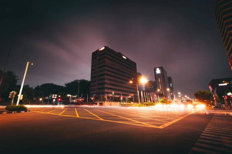 a city street filled with lots of traffic at night, by Patrick Ching, pexels contest winner, brutalist city, parking lot, gloomy lights in the sky, singapore