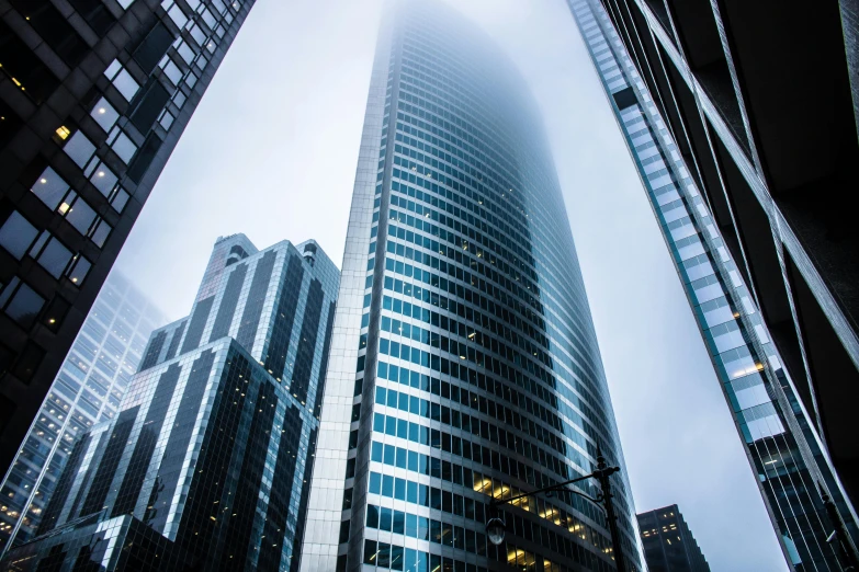 a very tall building in the middle of a city, pexels contest winner, modernism, low angle mist, skyscrapers, curvy build, thumbnail
