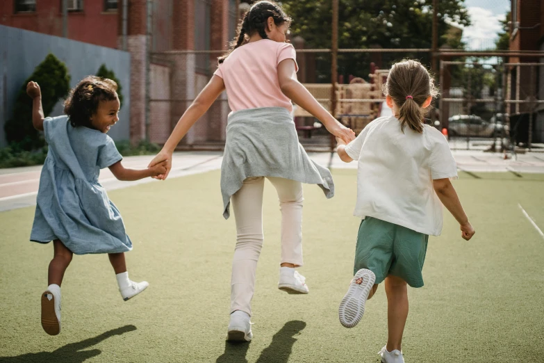 a group of young girls running across a tennis court, pexels contest winner, incoherents, hugging her knees, school courtyard, te pae, 1 4 9 3