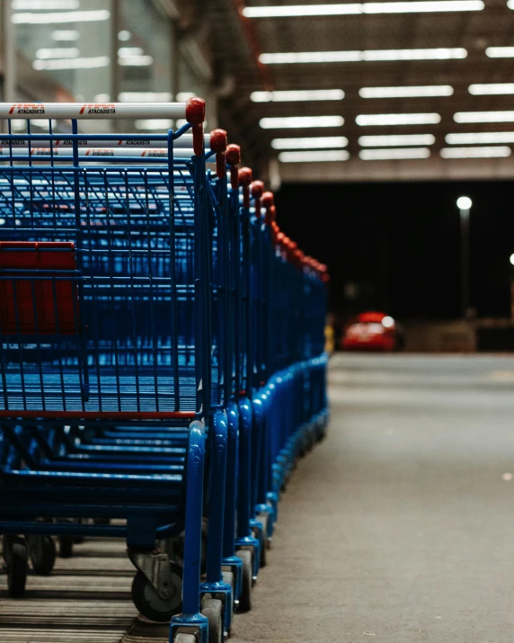 a row of blue shopping carts sitting next to each other, pexels contest winner, lgbtq, thumbnail, multiple stories, late evening