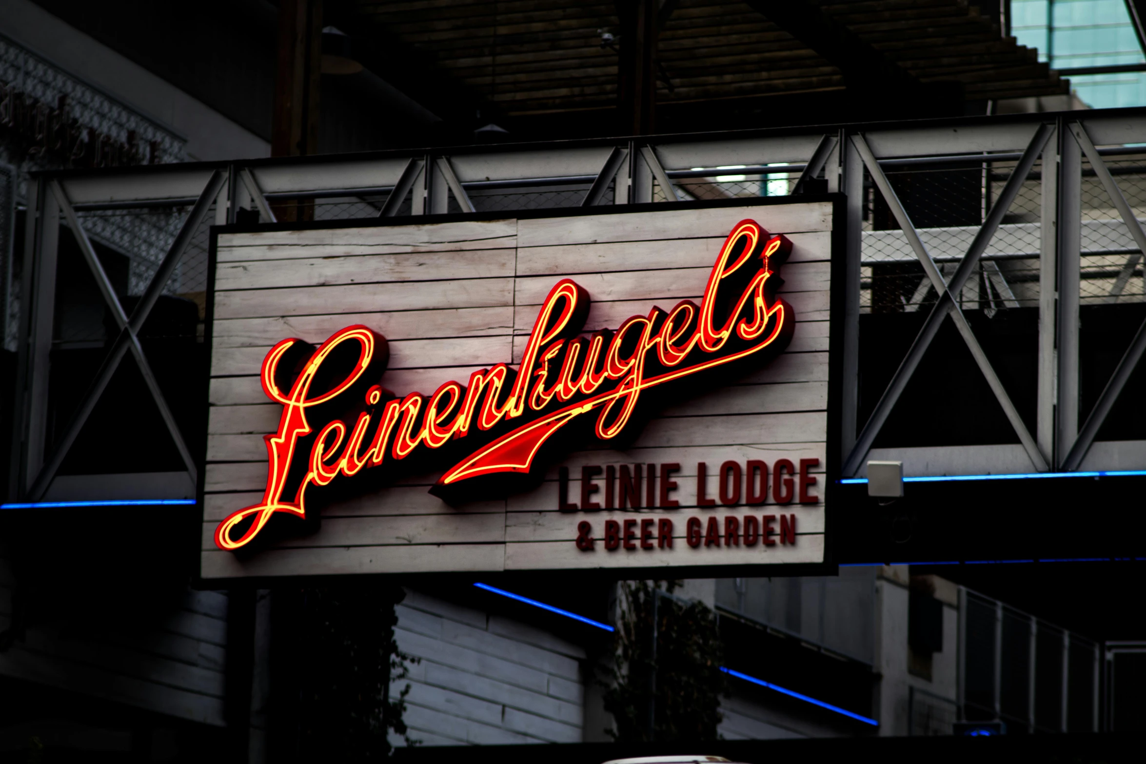 a neon sign on the side of a building, ledmund leighton, fan favorite, longhouse, levers