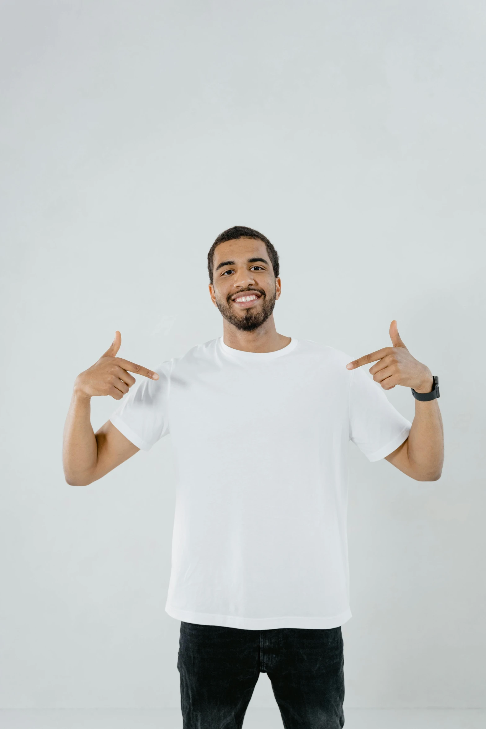 a man in a white t - shirt holding two thumbs up, pexels contest winner, white space in middle, ismail, promotional picture, no - text no - logo