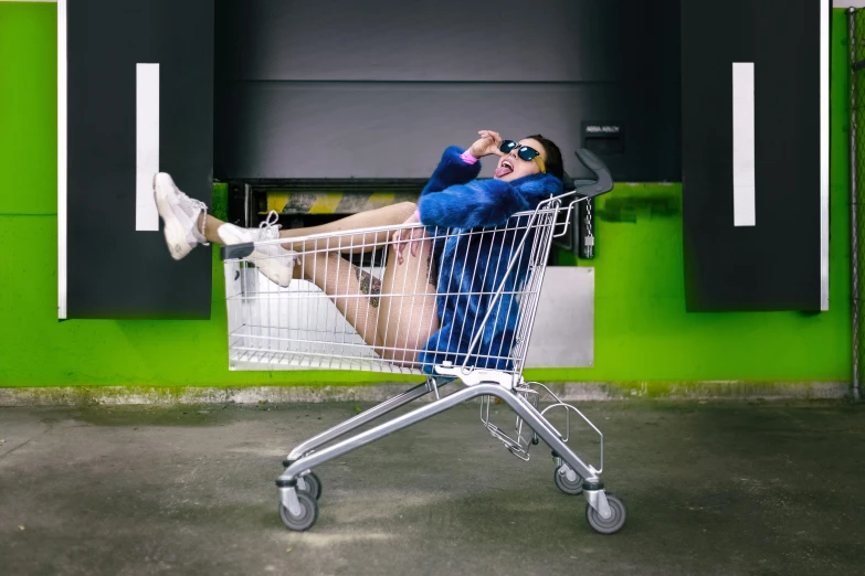 a man in a blue shirt sitting in a shopping cart, by Julia Pishtar, pexels contest winner, graffiti, sassy pose, hyper reali sm, ashteroth, rectangle