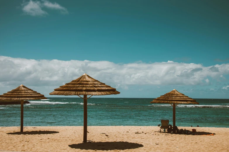 a group of umbrellas sitting on top of a sandy beach, unsplash contest winner, kauai springtime, avatar image, gazebos, thumbnail