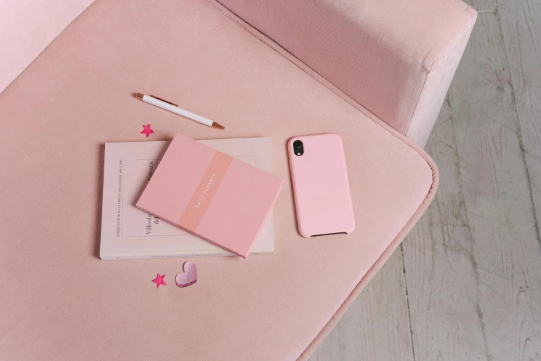 a pink phone sitting on top of a pink couch, inspired by Peter Alexander Hay, minimalism, silicone cover, notebook, light blush, 3 colours