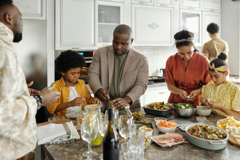 a group of people in a kitchen preparing food, fan favorite, father figure image, abcdefghijklmnopqrstuvwxyz, on kitchen table