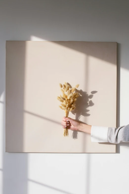 a woman holding a bunch of flowers in front of a painting, a minimalist painting, inspired by Robert Mapplethorpe, trending on unsplash, back light, 144x144 canvas, made of dried flowers, vanilla - colored lighting