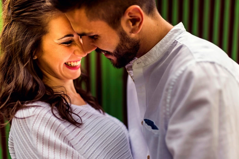 a man and a woman standing next to each other, a photo, pexels contest winner, earing a shirt laughing, profile image, spanish, lovers eat