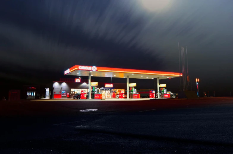 a gas station is lit up at night, inspired by Elsa Bleda, pexels contest winner, hyperrealism, under a gray foggy sky, epic red - orange moonlight, 2 5 6 x 2 5 6 pixels, paul barson