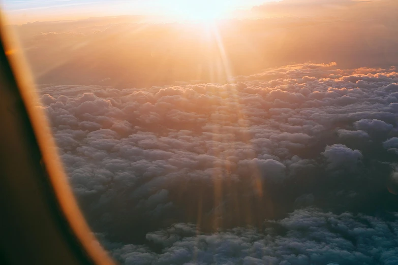 a view of the sun through an airplane window, pexels contest winner, light pink clouds, music video, holy rays, instagram post