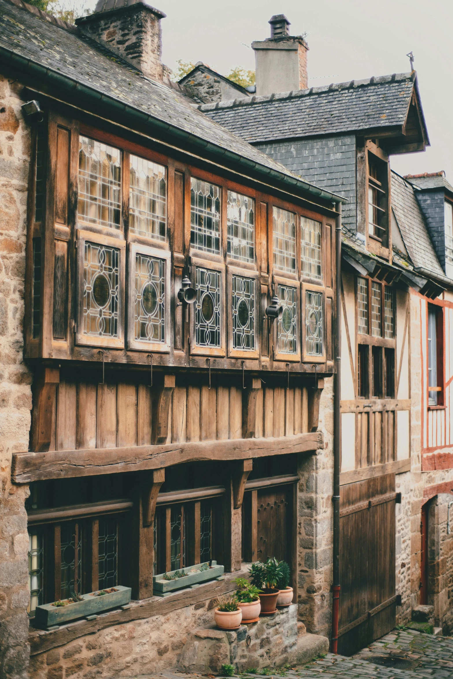 a couple of buildings that are next to each other, pexels contest winner, arts and crafts movement, large windows to french town, wood and gold details, slide show, rustic