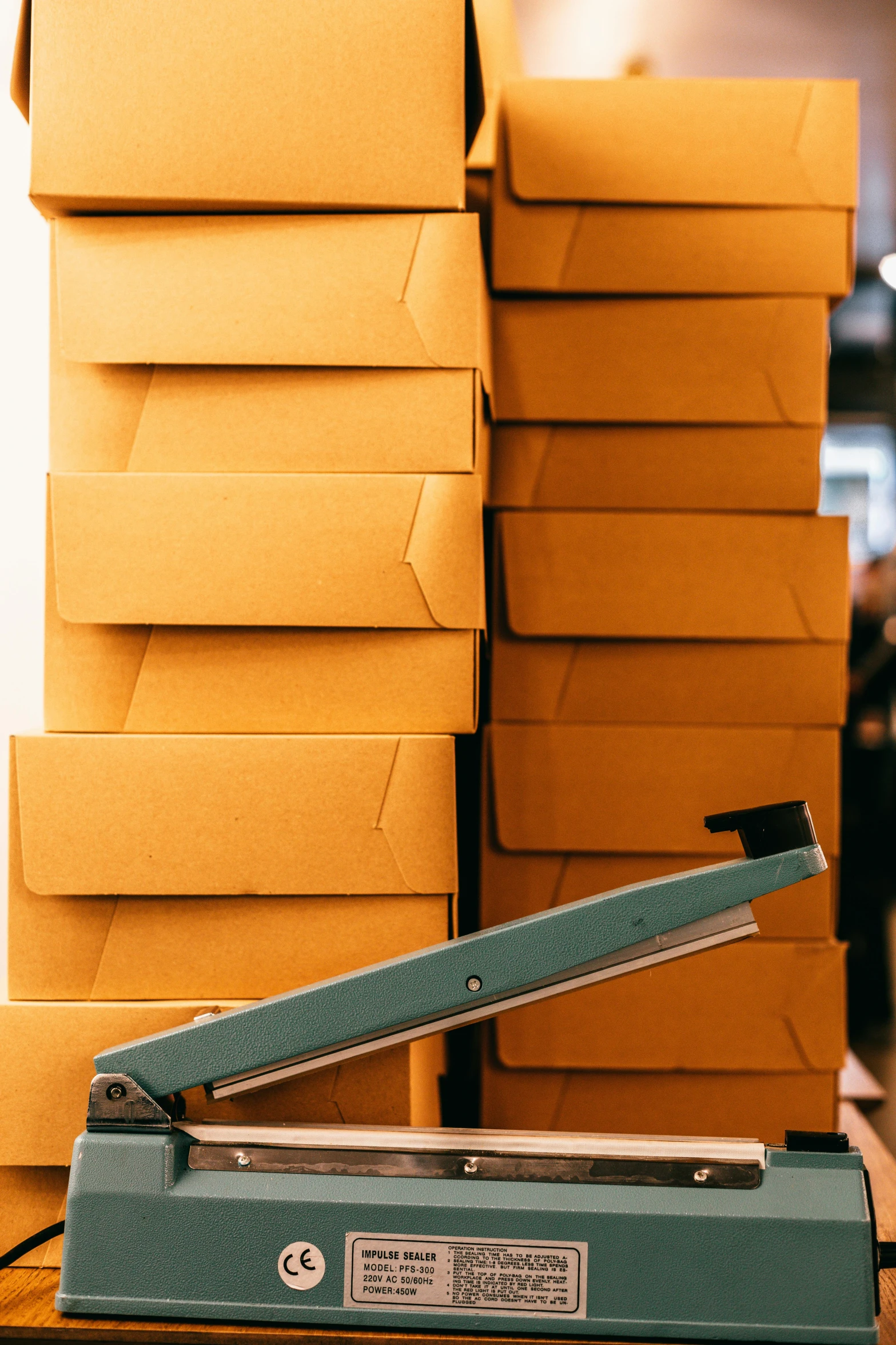 a bunch of boxes stacked on top of each other, trending on unsplash, private press, box cutter, in a factory, caramel, thumbnail