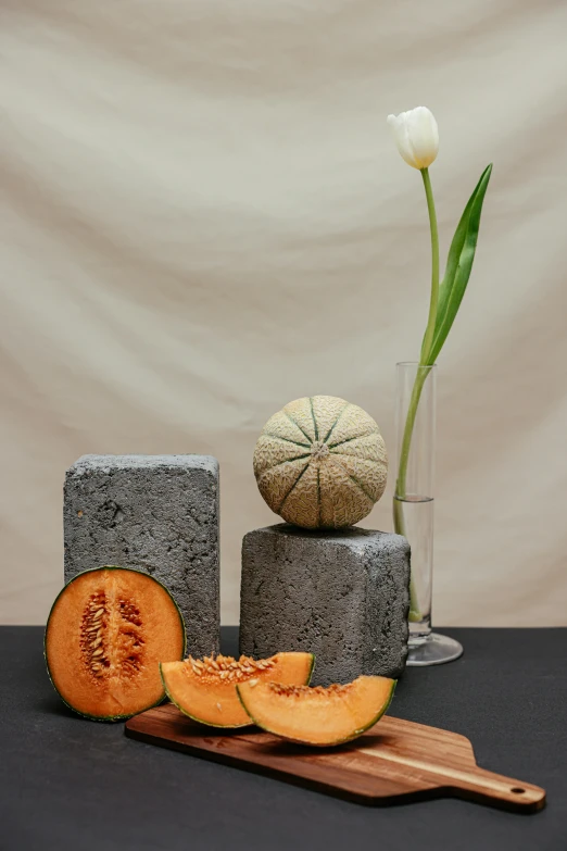 a wooden cutting board sitting on top of a table, a still life, inspired by Giorgio Morandi, concrete art, wearing a melon, orange rocks, ikebana, on textured base; store website