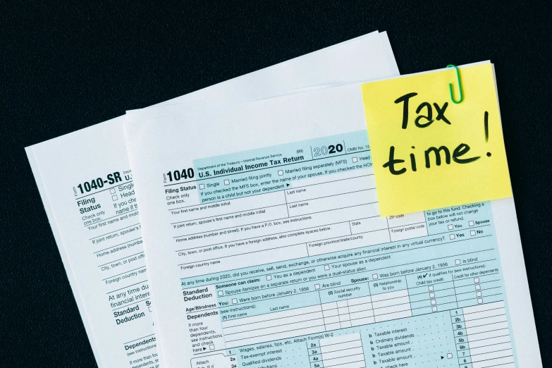 a pile of tax forms sitting on top of a table, by Carey Morris, pexels contest winner, fan favorite, avatar image, yellow and black color scheme, lunar time