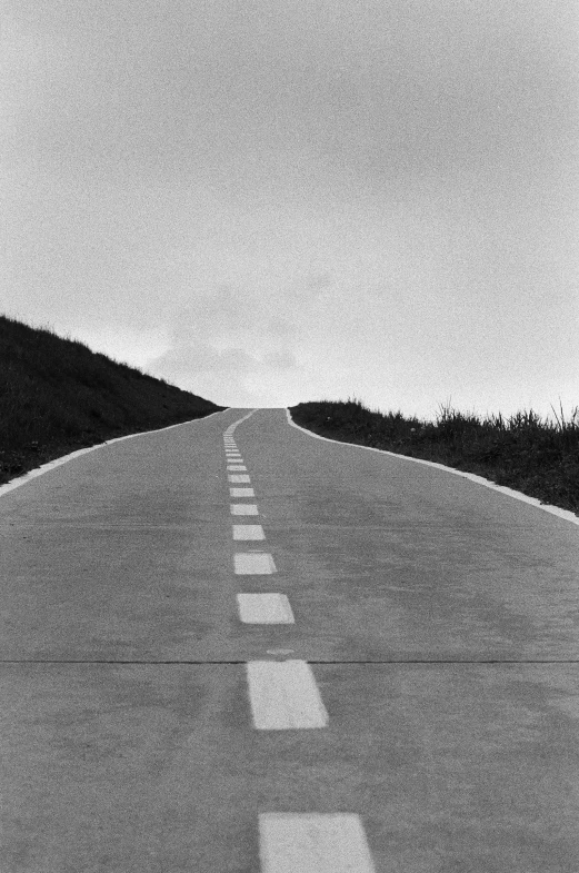 a black and white photo of an empty road, by Enzo Cucchi, yoichi hatakenaka, be running up that hill, ( ( photograph ) ), ( conceptual art )