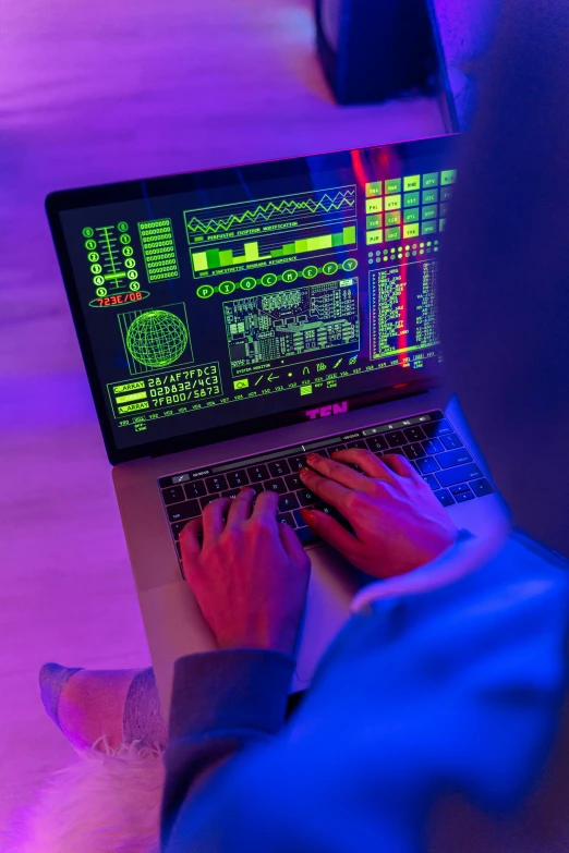 a person sitting in front of a laptop computer, by Byron Galvez, pexels, holography, lasers and neon circuits, colorful computer screen, using synthesizer, hacking into the mainframe