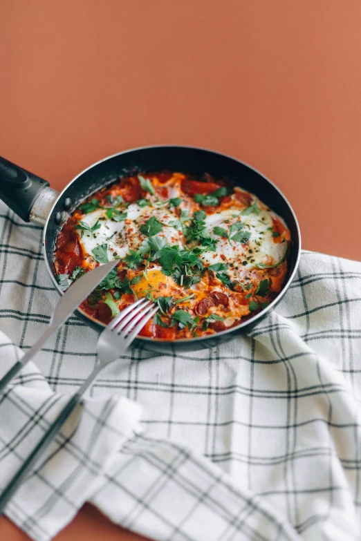 a pan filled with eggs on top of a table, by Carey Morris, pexels contest winner, hurufiyya, lasagna, gif, chilaquiles, 15081959 21121991 01012000 4k