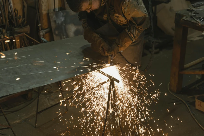 a man that is working on some kind of thing, by Thomas Furlong, pexels contest winner, arbeitsrat für kunst, welding torches for arms, 9 9 designs, facing sideways, mid riff