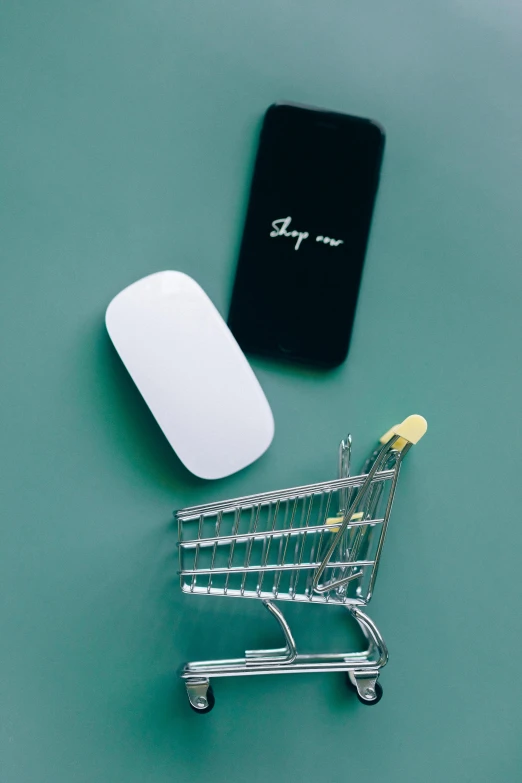 a computer mouse sitting next to a shopping cart, profile image, flatlay, no - text no - logo, mobile app