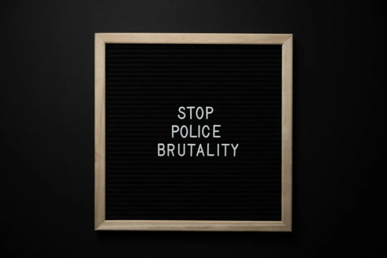 a black board with the words stop police brutality written on it, shutterstock, brutalist shiro, shot on hasselblad, but is mostly wood, alessio albi