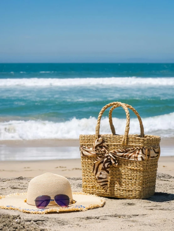 a hat, sunglasses and a straw bag on a beach, by Elaine Hamilton, pexels contest winner, hollister ranch, square, handbag, medium