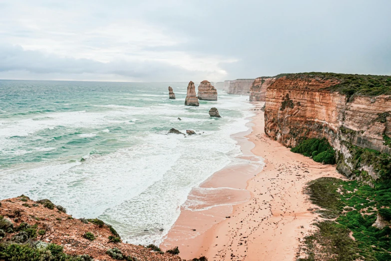 a sandy beach next to the ocean on a cloudy day, pexels contest winner, baroque, cliffs, aussie, group of seven, “the ultimate gigachad