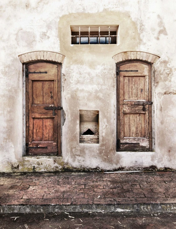 a red fire hydrant sitting in front of a building, an album cover, inspired by Pieter de Hooch, pexels contest winner, two wooden wardrobes, weathered, symmetrical doorway, poop