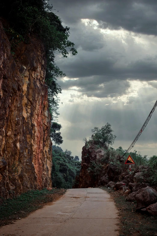 a large crane sitting on top of a dirt road, a matte painting, unsplash contest winner, photorealism, malaysia jungle, cliff edge, under construction, dramatic lighting - n 9