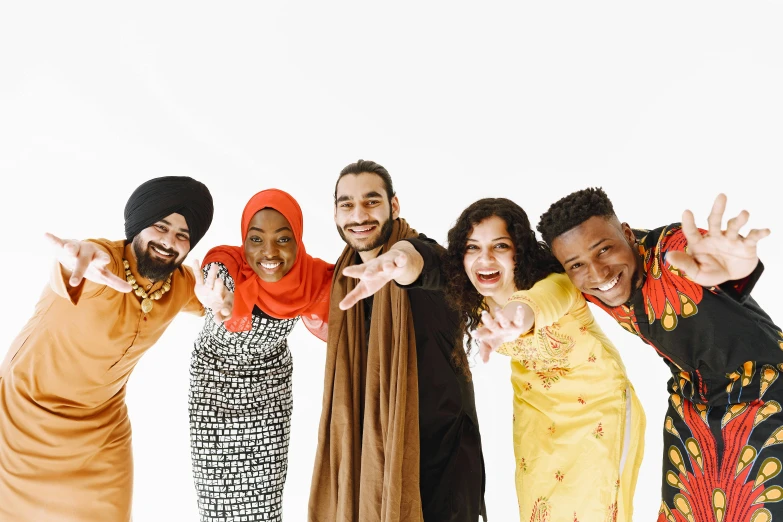 a group of people standing next to each other, trending on pexels, wearing a turban, white background”, smiling, background image